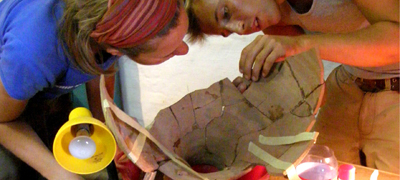 Students reconstructing an amphora from the excavation