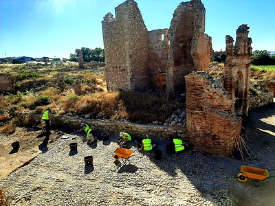 Students excavating the medieval street next to the ruins of the old town of Belchite