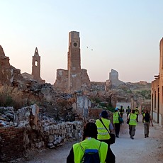 Students walking through the ruins of the old town of Belchite at dawn